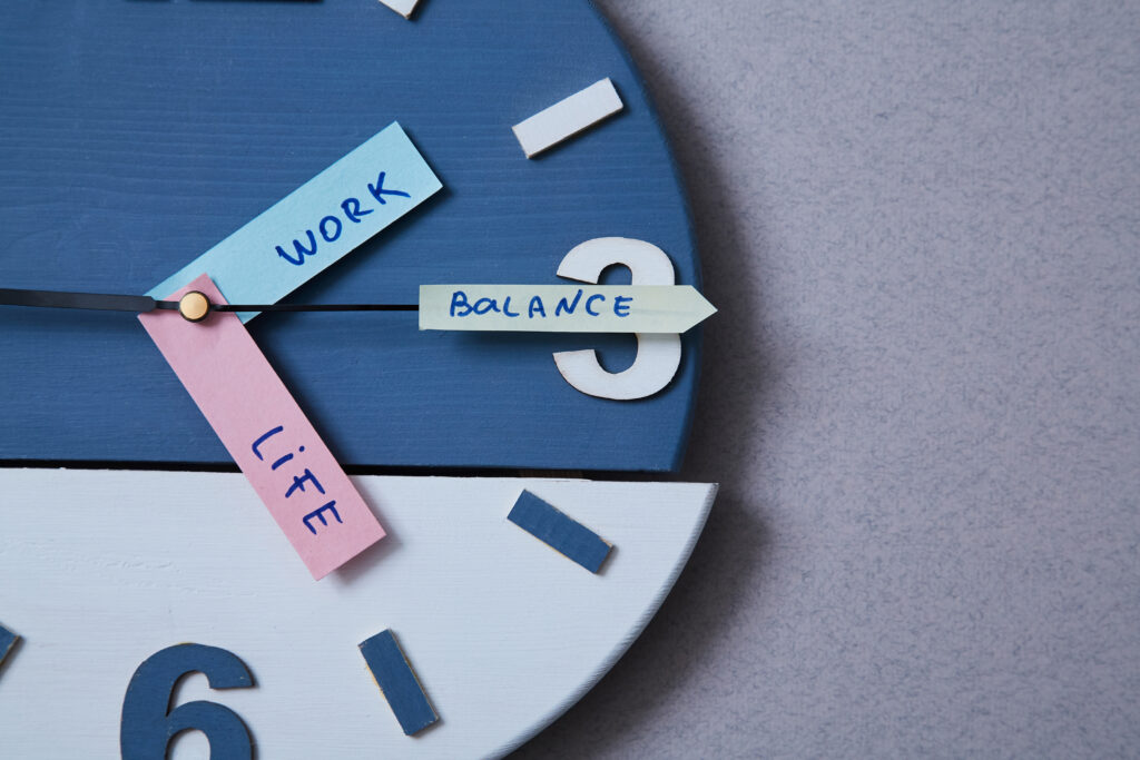 Work life balance choice concept. Clock closeup and arrows telling.
